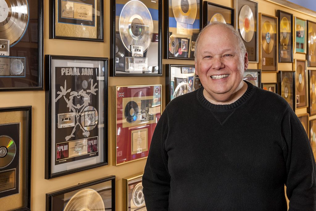mastering engineer bob ludwig standing in front of awards