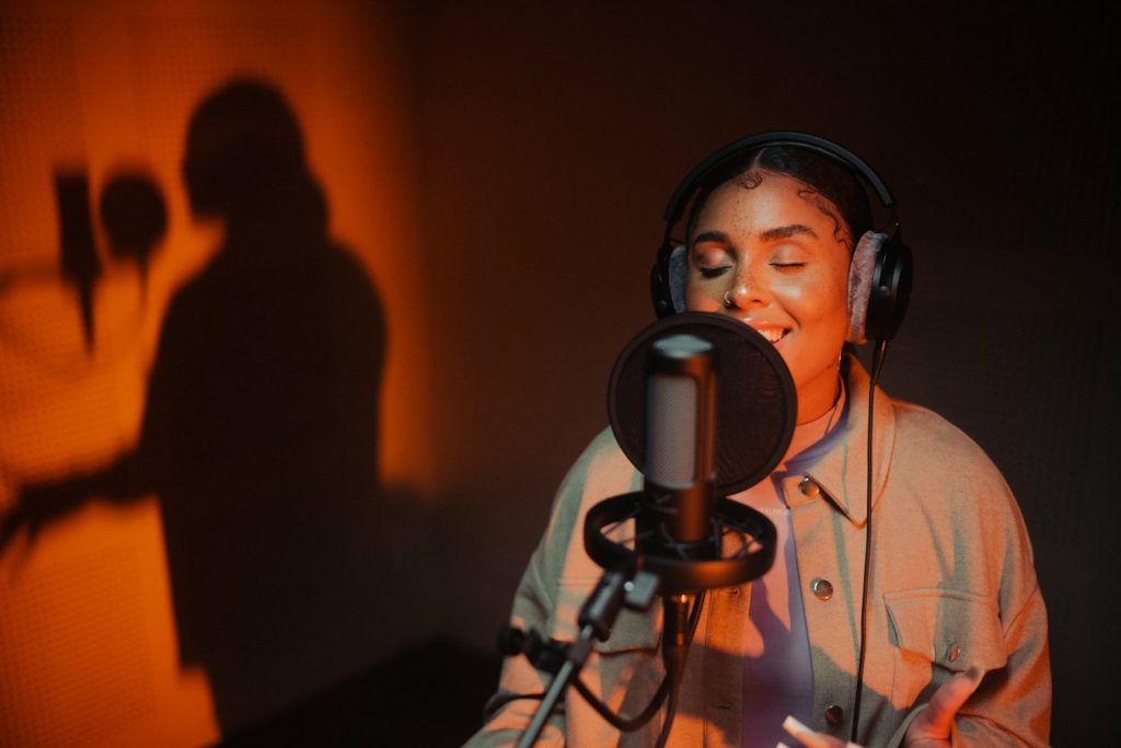 person singing into and wearing Beyerdynamic PRO X products