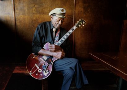 Chuck Berry holding his Gibson guitar wearing a sailors cap