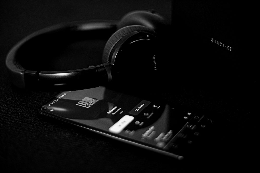 phone with spotify next to headphones