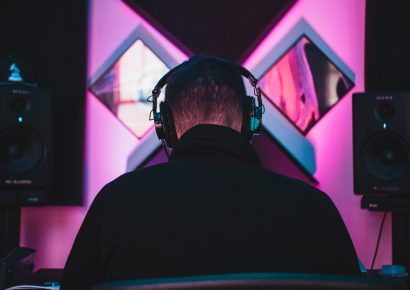Person listening to music in colourful studio
