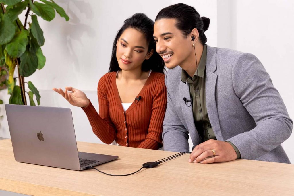 two people talking into microphones plugged in to RODE AI-Micro